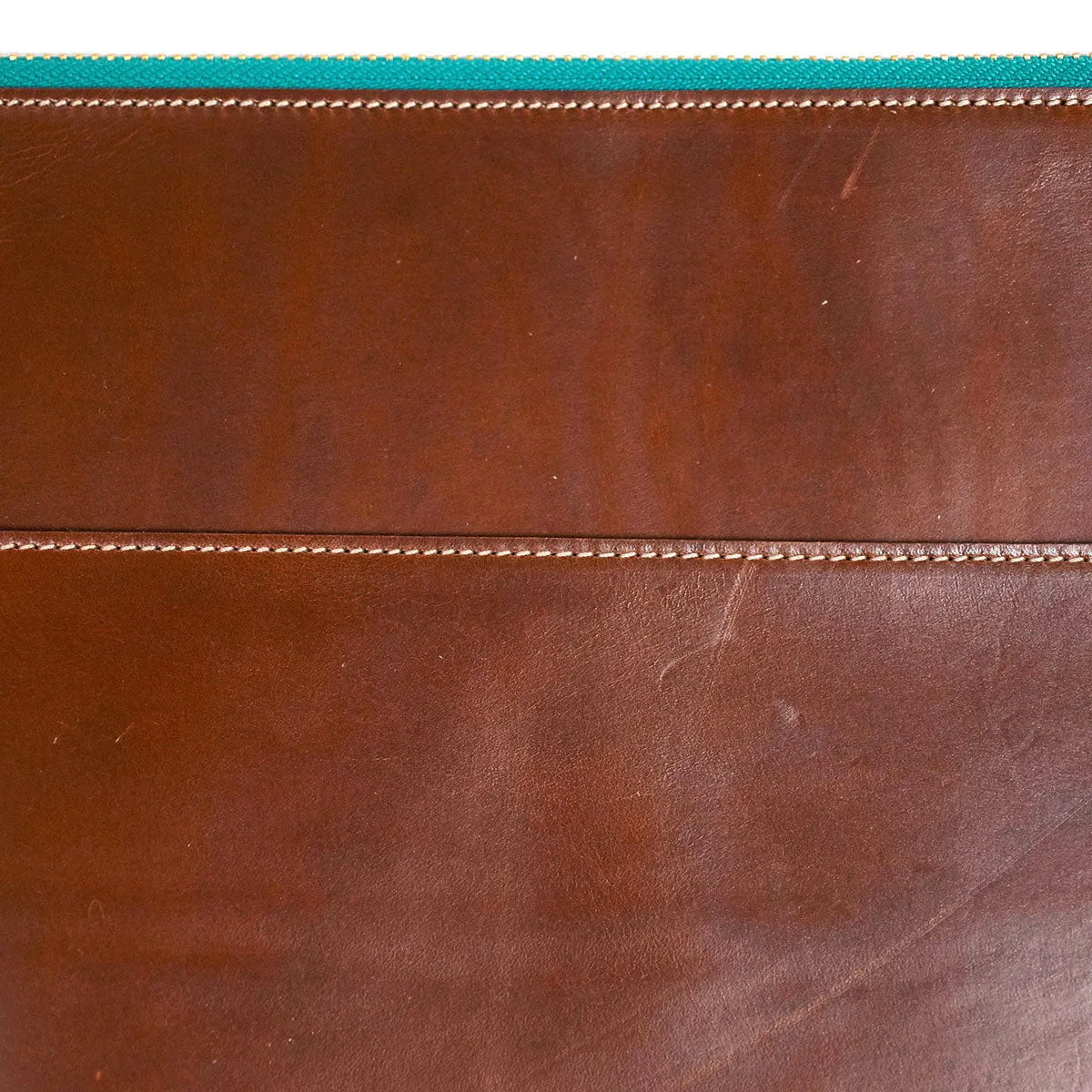 Brown leather portfolio with green zipper